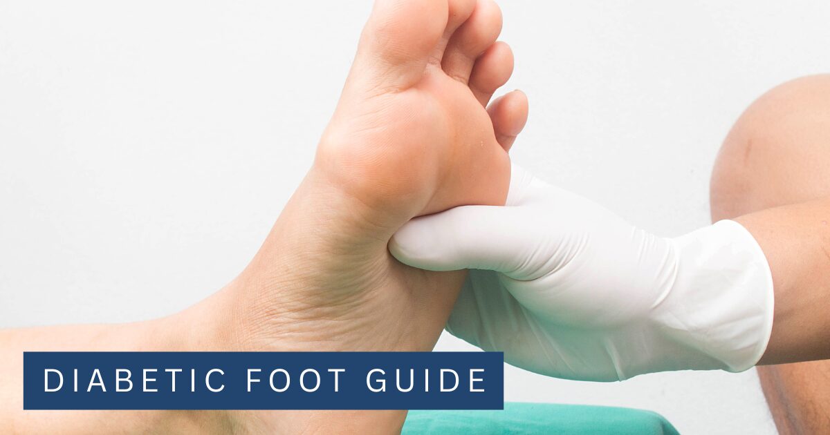 Gloved clinician supporting a patient's bare foot against a plain background during a foot examination